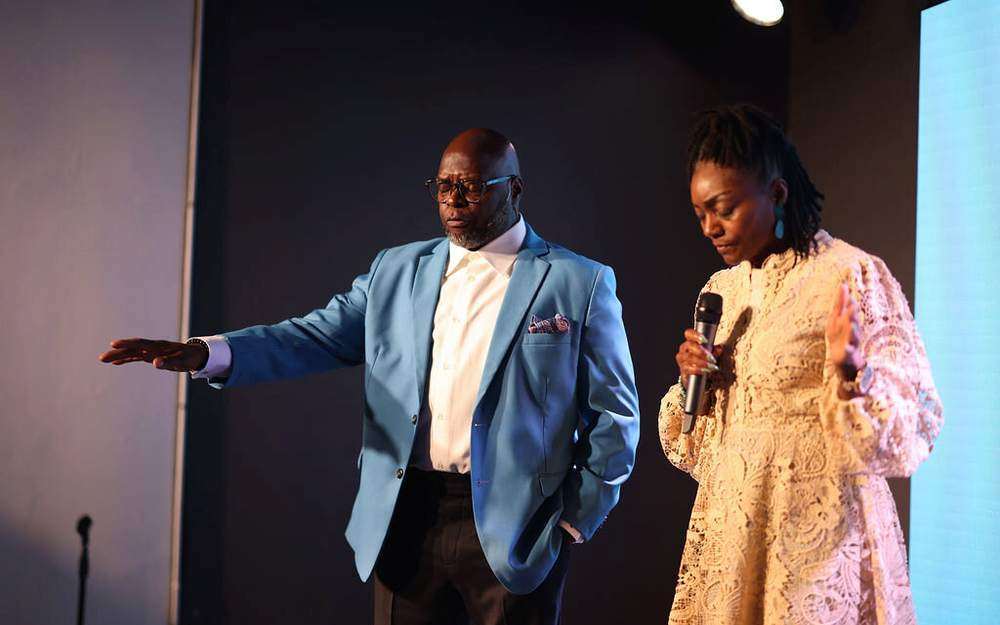 Pastor Anthony Guidry and a worship leader on stage during a Sunday service at Intentional Church in Powder Springs, Georgia