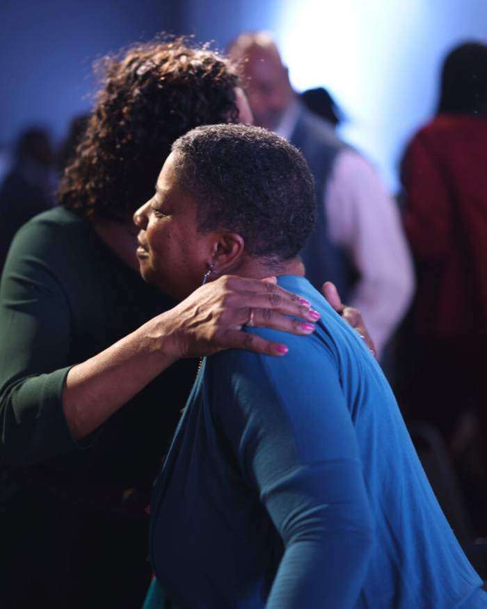 Two partners talking and laughing together after service at Intentional Church in Powder Springs, Georgia