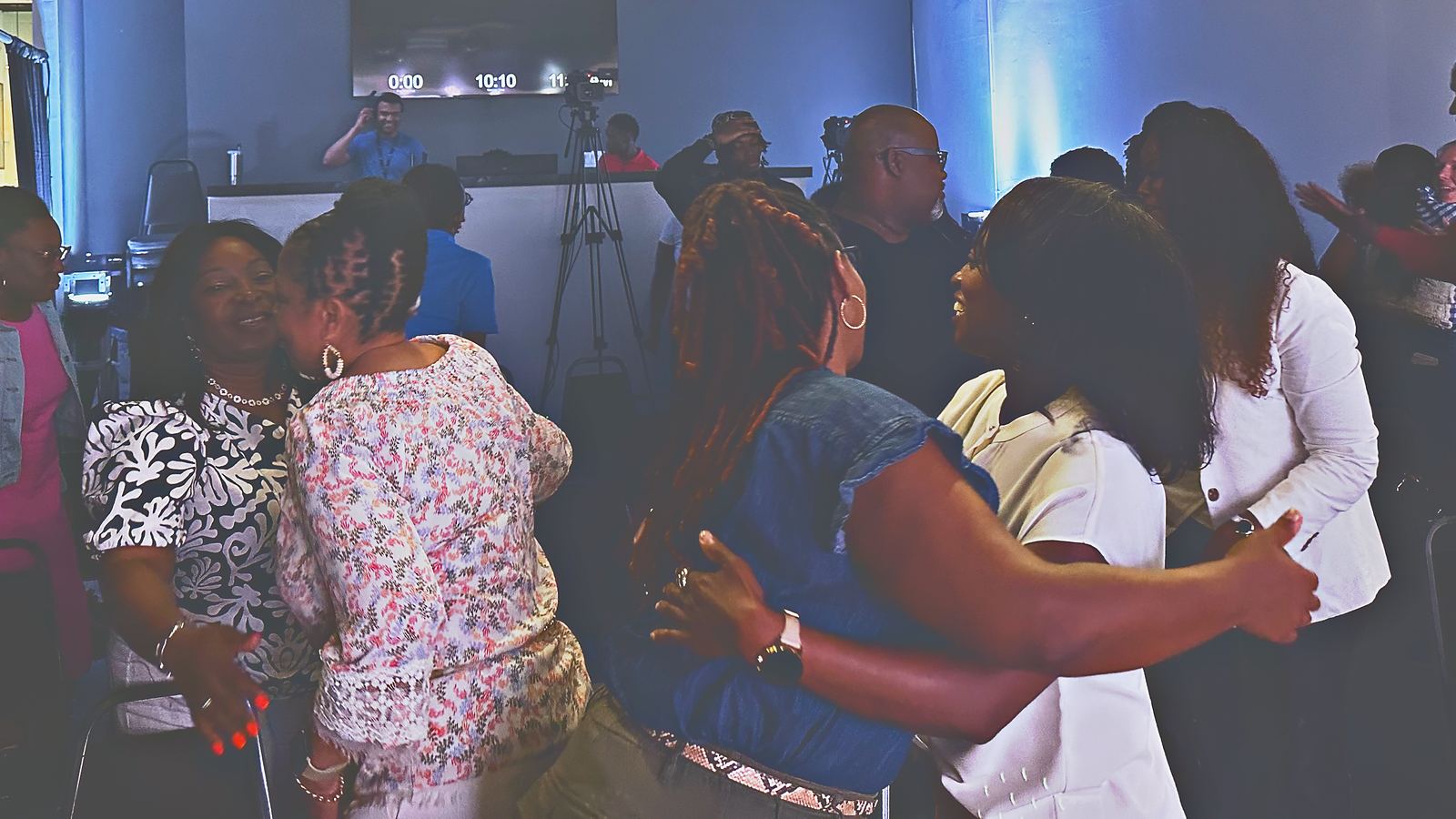 Partners greeting and embracing one another after Sunday service at Intentional Church in Powder Springs, Georgia