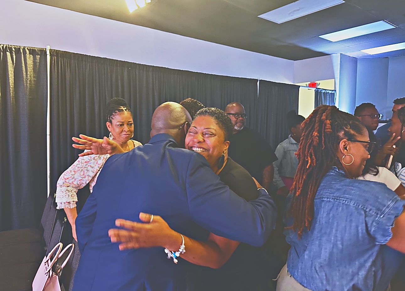 Pastor Anthony Guidry greeting and embracing a member of the congregation after a Sunday service at Intentional Church in Powder Springs, Georgia