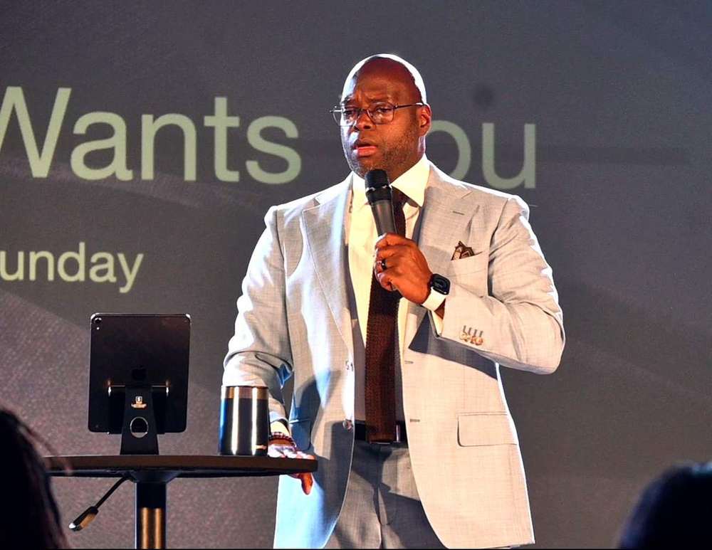 Pastor Anthony Guidry preaching with a microphone at Intentional Church in Powder Springs, Georgia
